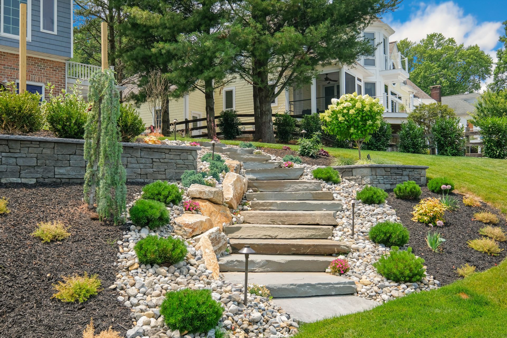 There are stairs leading up to a house in the backyard.