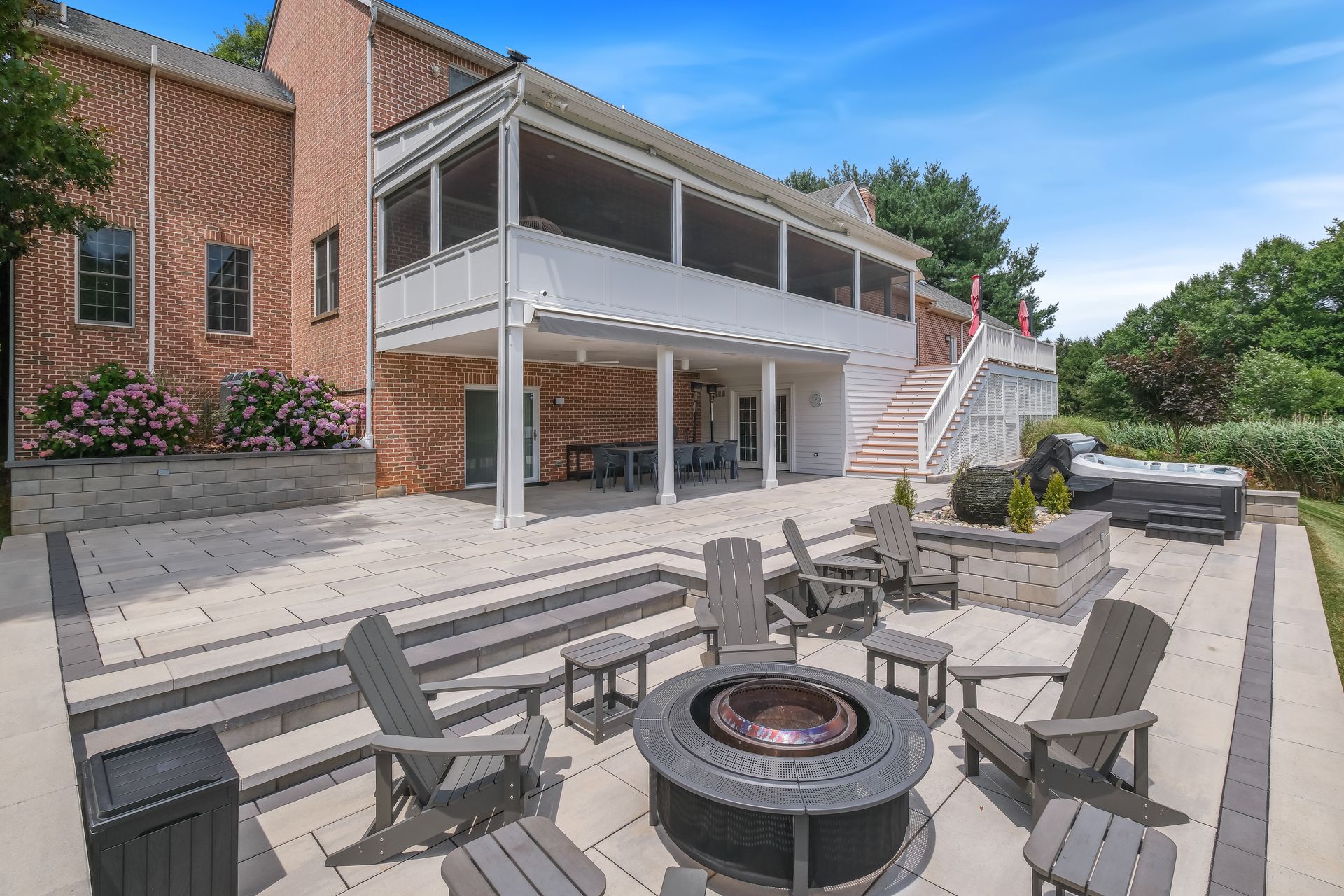 There is a fire pit in the middle of the patio.