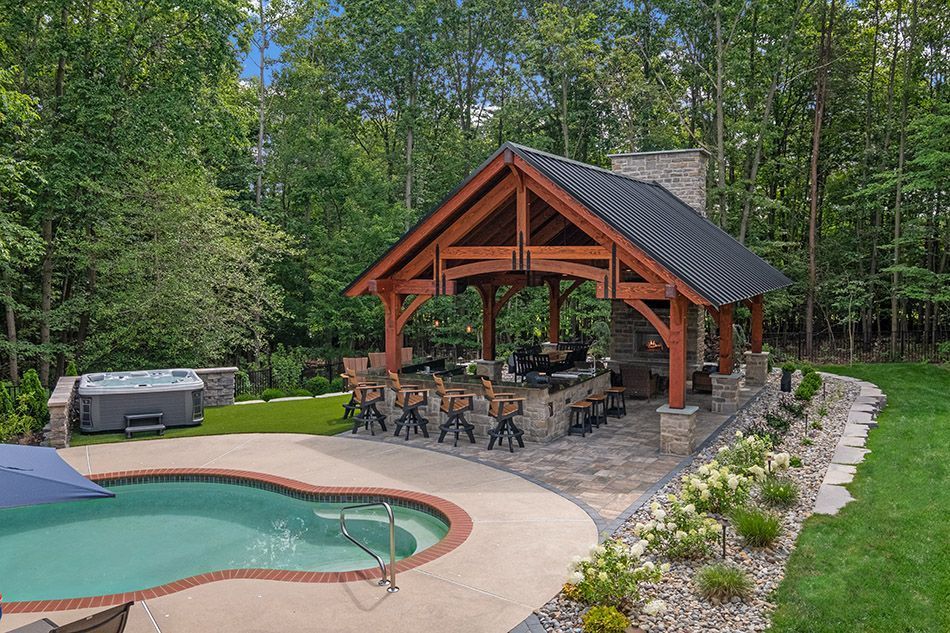 A large swimming pool with a pavilion in the backyard.