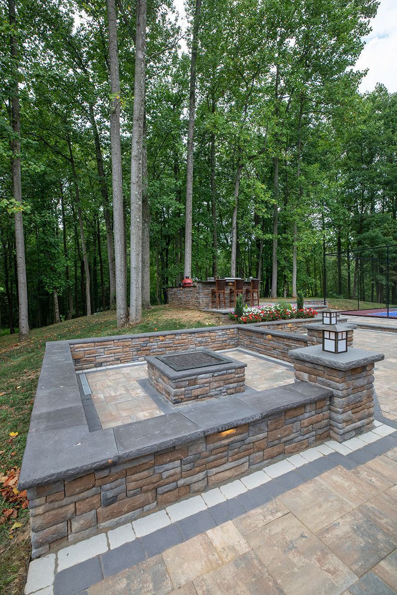 There is a fire pit in the middle of the patio.