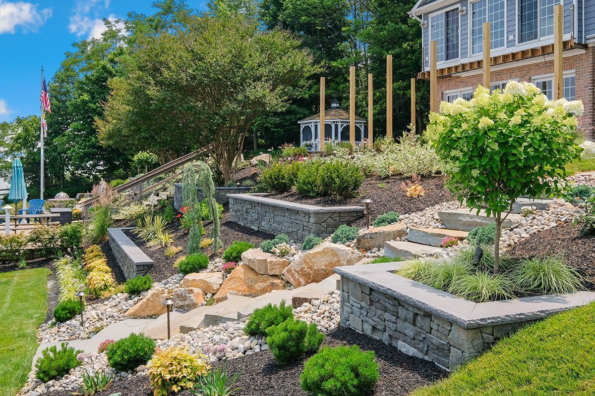 A large house with a lush green landscape in front of it.
