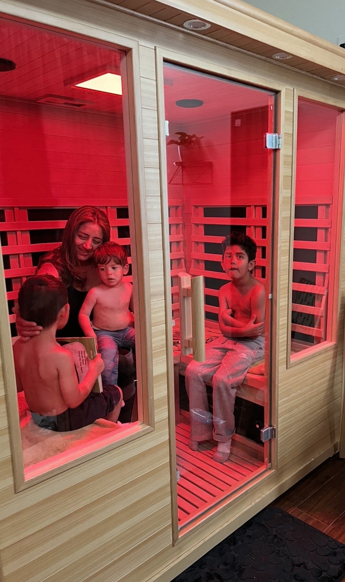 A family is sitting in an infrared sauna.