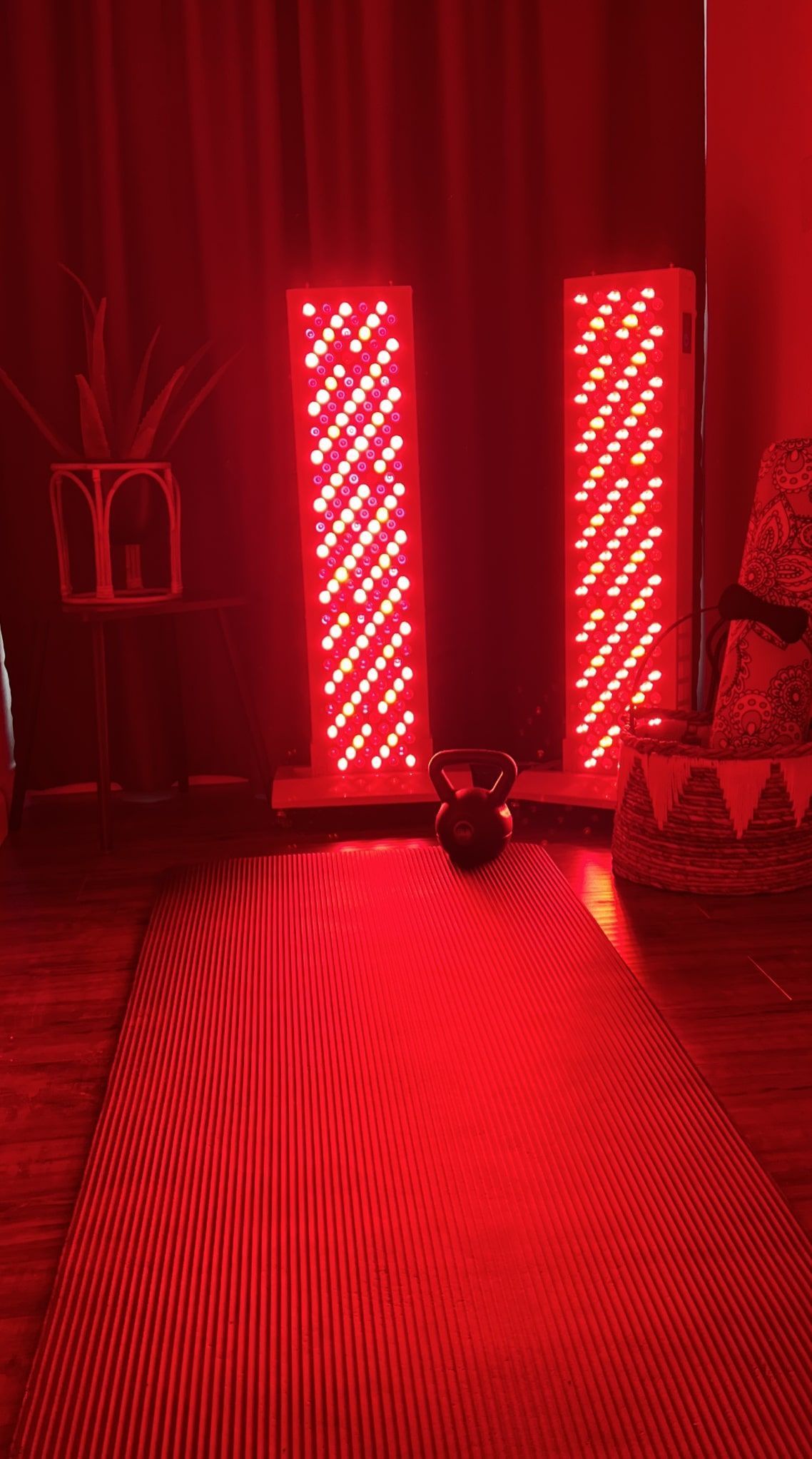 A red light is shining on a yoga mat in a living room.