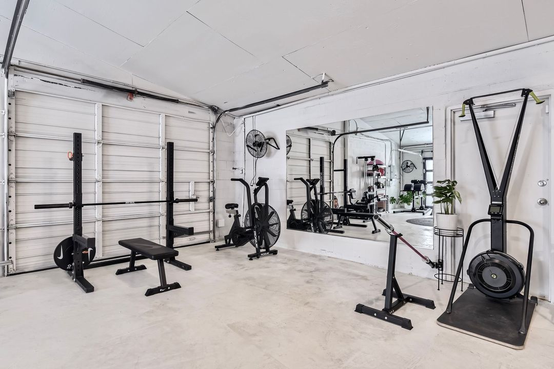 A gym with a lot of exercise equipment in it