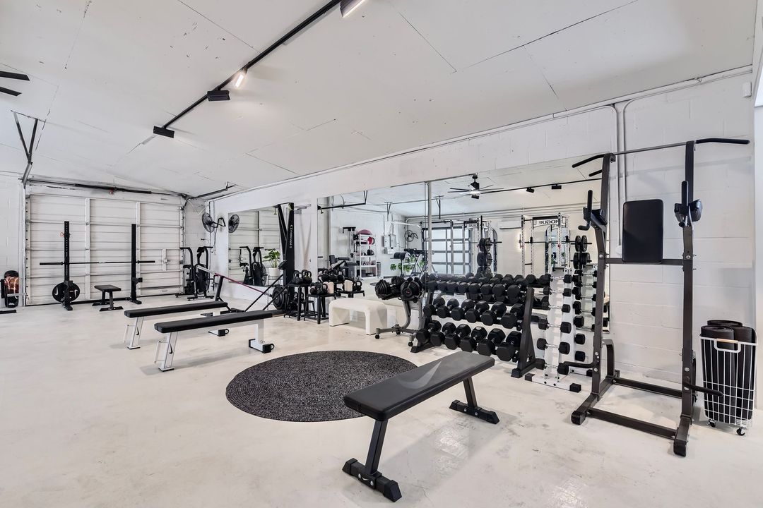 A gym with a lot of equipment and a bench for women's workout