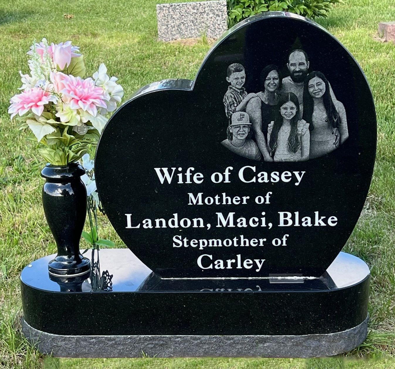 A heart shaped gravestone for wife of casey mother of landon maci blake stepmother of carley