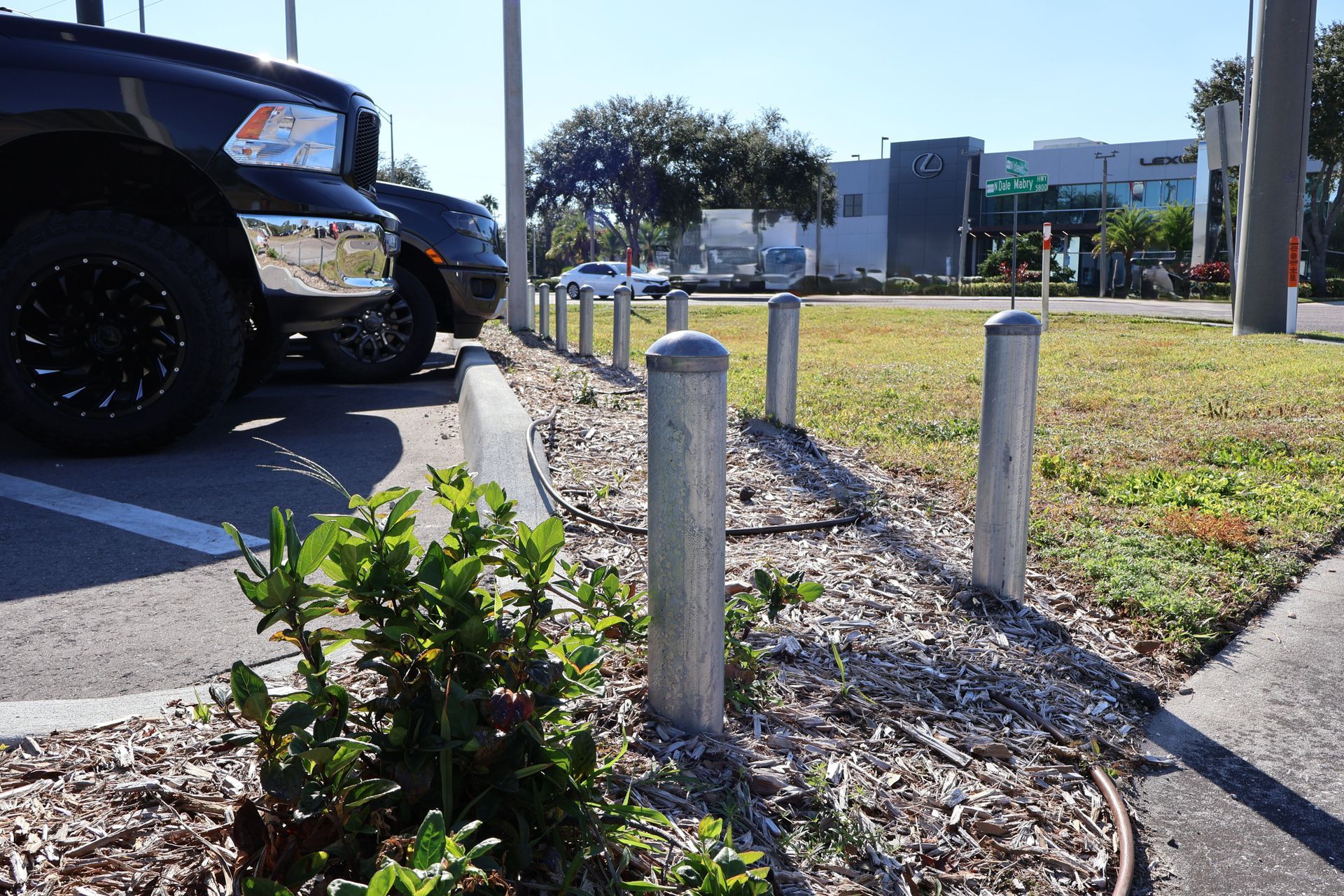 Commercial aluminum bollards installation at a Lexus car dealership in Tampa, FL