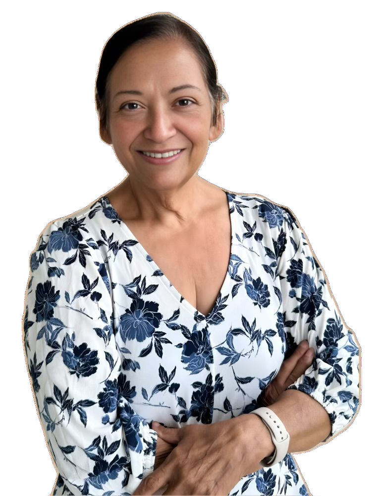 Smiling older woman with dark hair and a floral top, arms crossed. Beige background.