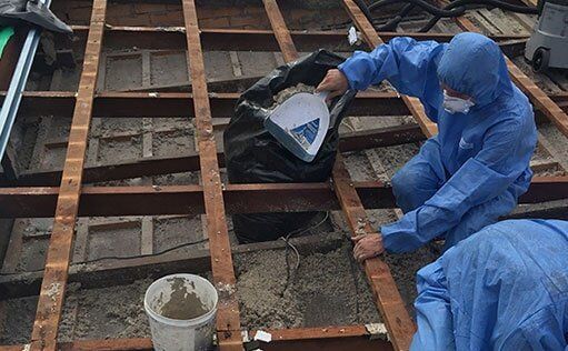 Worker In Full Gear Removing Asbestos — Roofing Services in Rockhampton, QLD