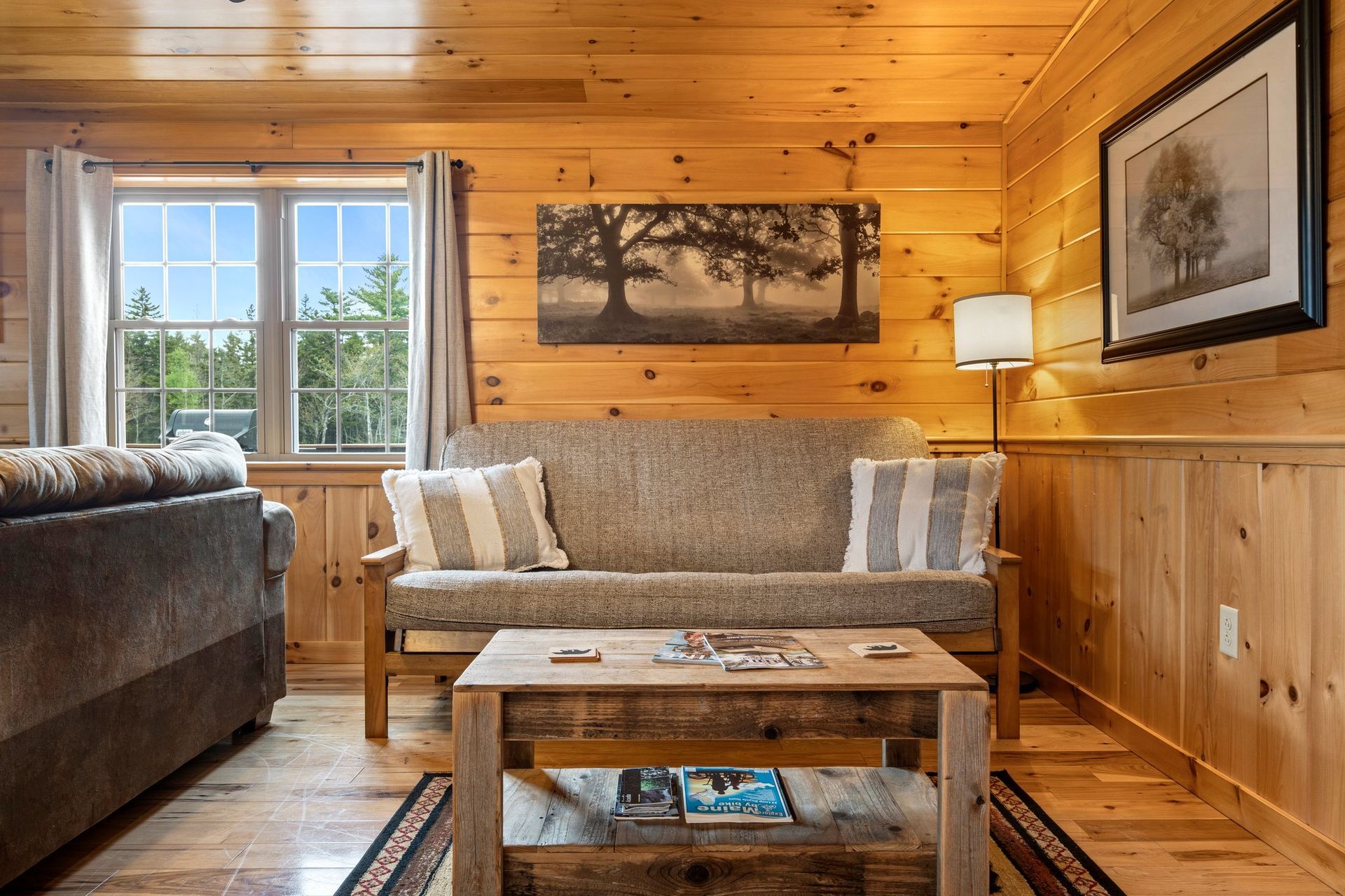 A living room in a log cabin with a couch and a coffee table.