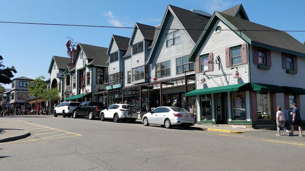 A row of buildings with cars parked in front of them
