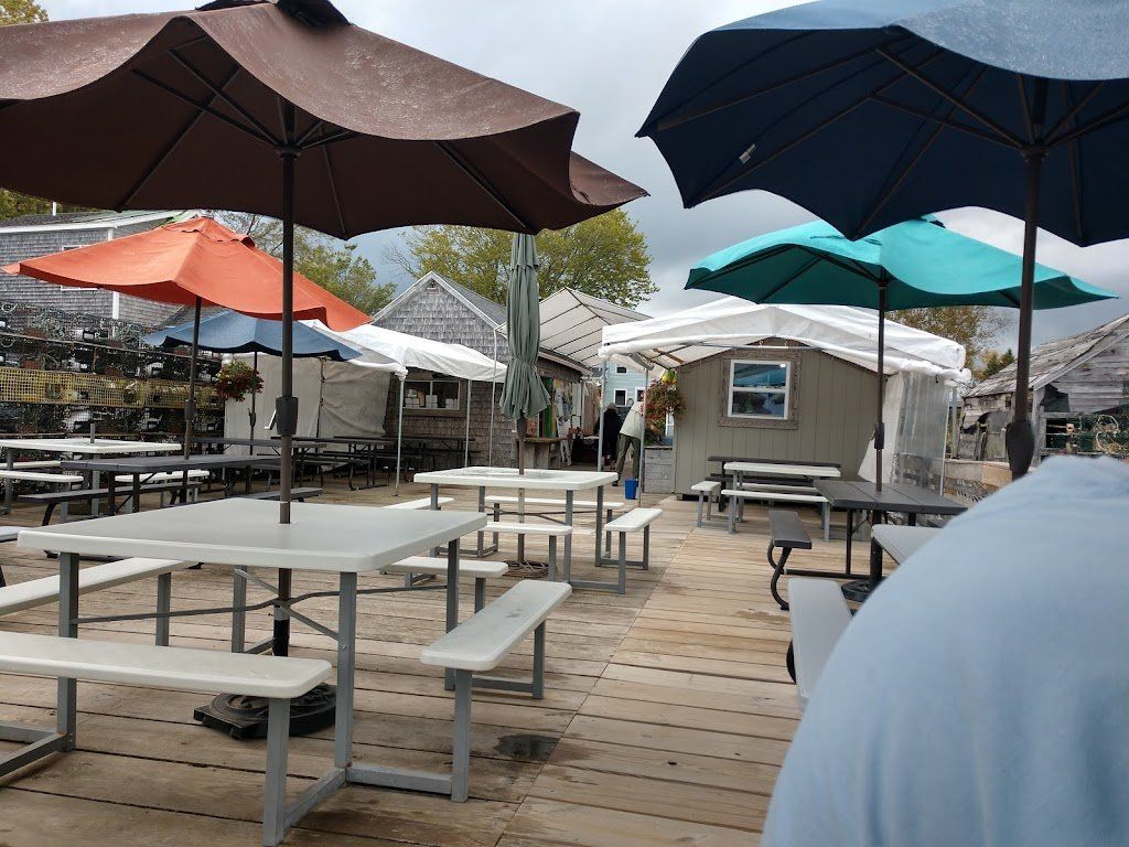 A group of picnic tables and umbrellas on a deck