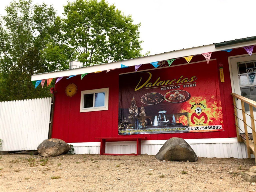 A red building with a large sign on the side of it.