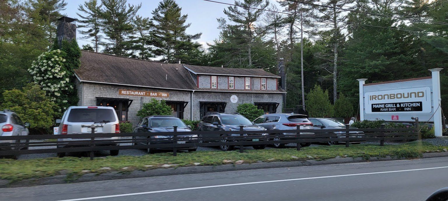 A group of cars are parked in front of a building.