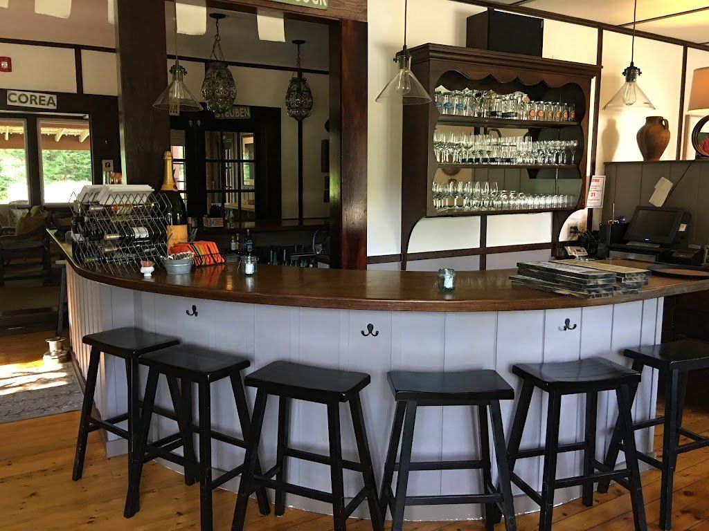 A restaurant with a long bar and stools
