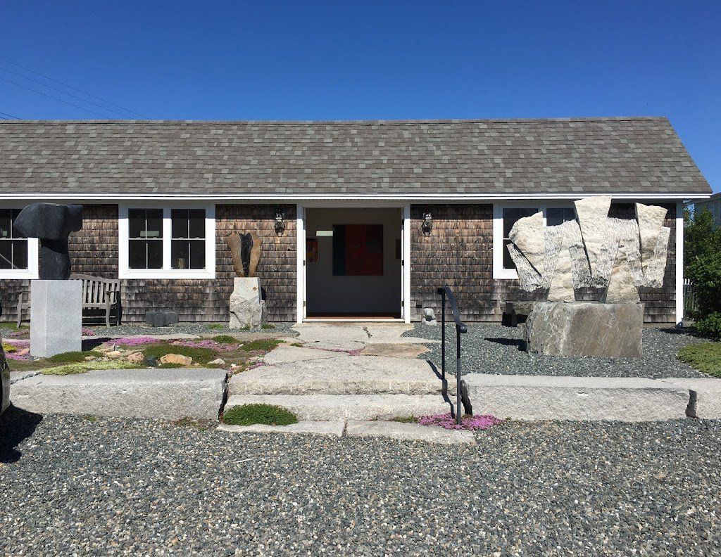 A house with a gray roof and a statue in front of it