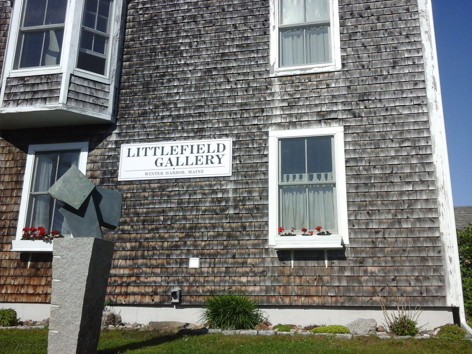 A building with a sign that says littlefield gallery