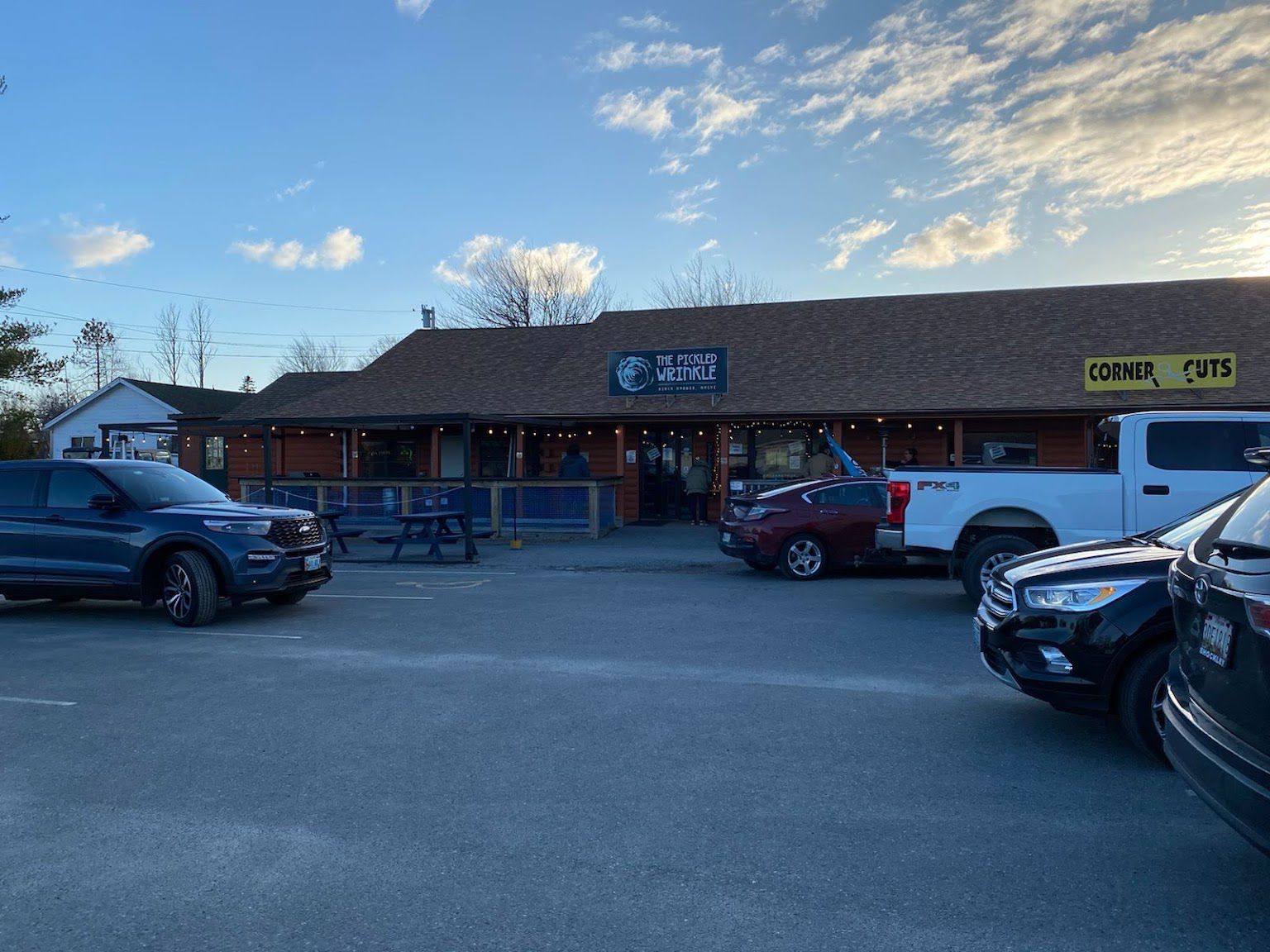 A lot of cars are parked in front of a building.