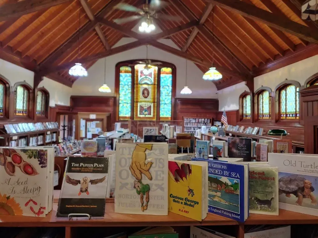 A library filled with books and a stained glass window