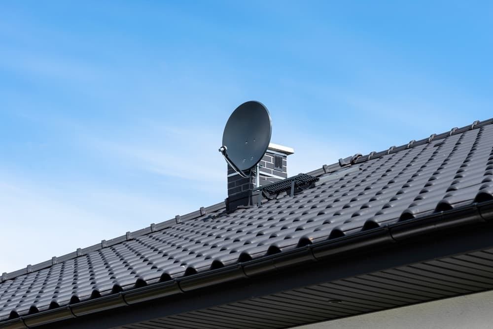 A Satellite Dish Is Mounted On The Roof Of A House — Coastwide Antennas In Woy Woy, NSW