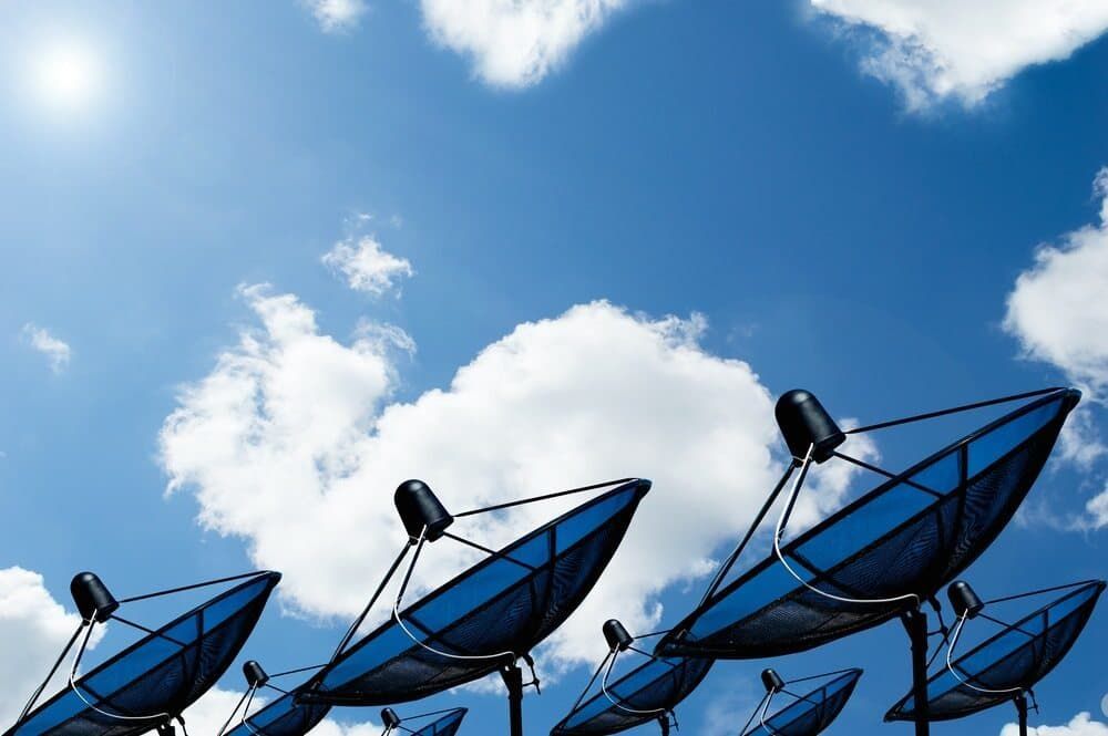 A Row Of Satellite Dishes Against A Blue Sky With Clouds — Coastwide Antennas In Ourimbah, NSW