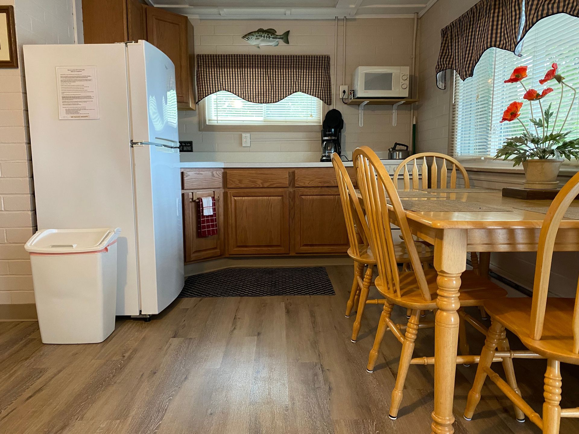 A kitchen with a table and chairs and a refrigerator.