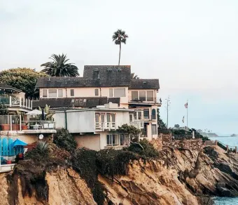Yellow stethoscope on a light blue background, angled from upper right to lower left.