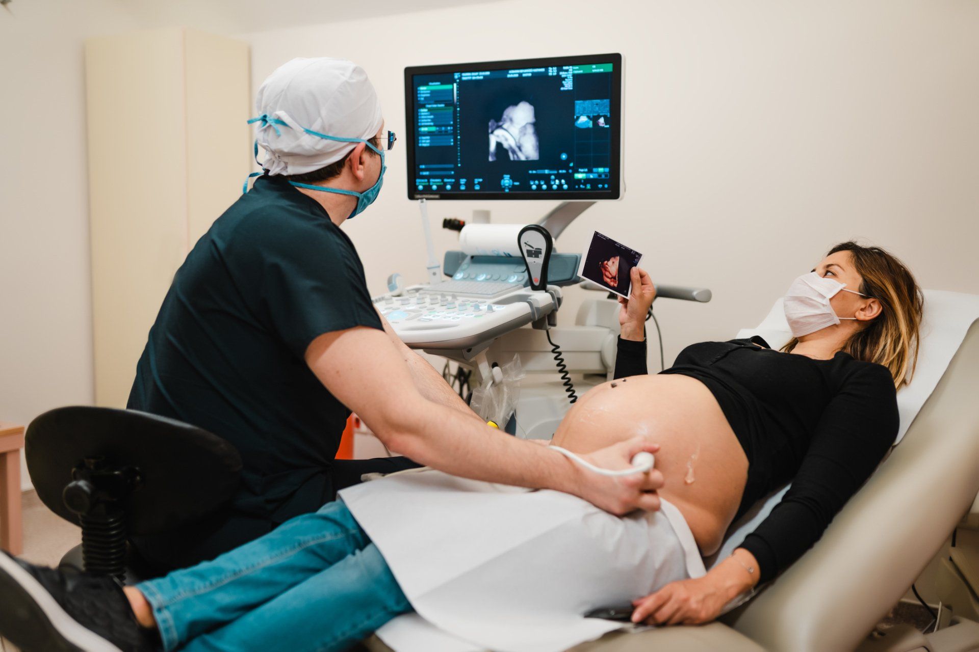 Pregnant woman watching her baby on the ultrasound — New Hartford, NY — Oxford Medical Imaging