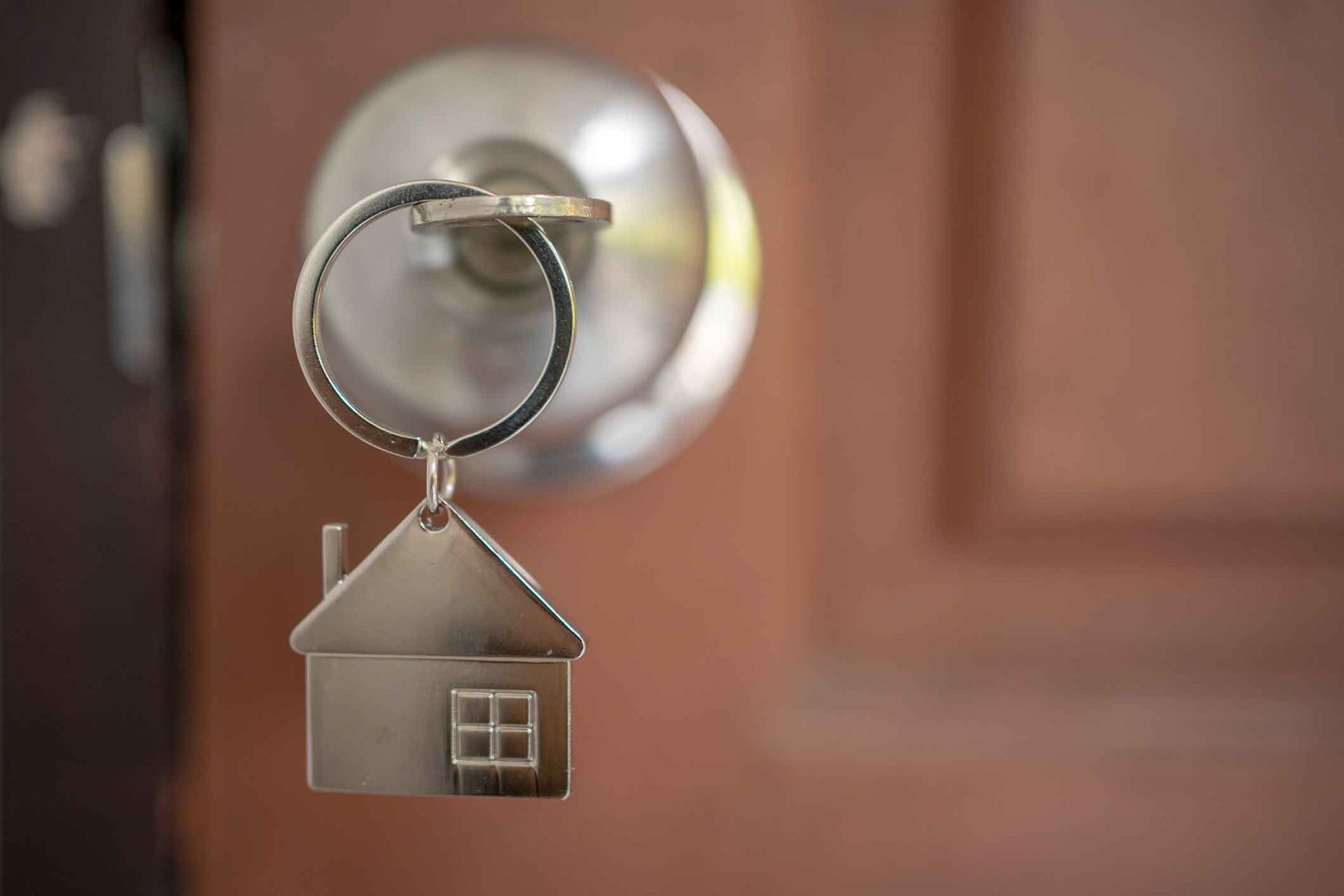 Silver house key in a door – Springfield, MO - Shirley Franklin Team