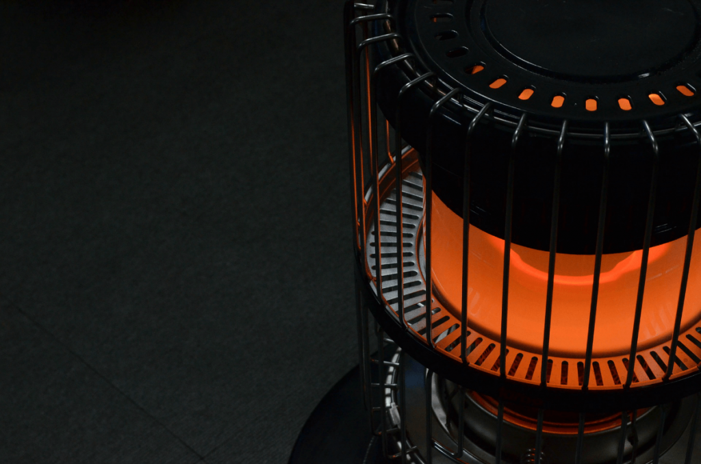 A close up of a heater with a flame coming out of it.