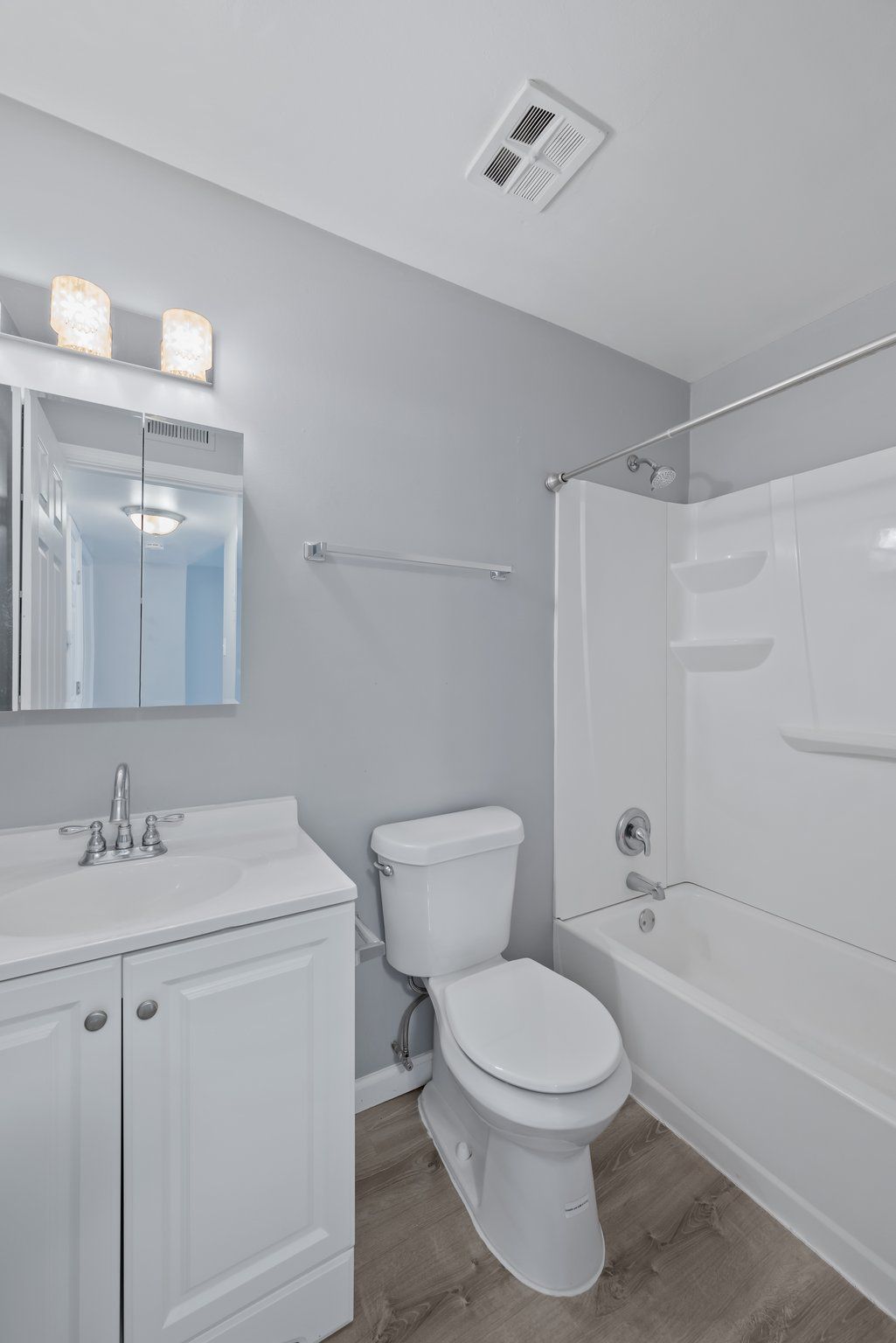 A bathroom with a toilet , sink , and bathtub.