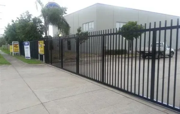 Black Sliding Security Gate — Brisbane, QLD — Hills Fencing Security Picket Fence & Gate around Commercial Property Perimeter in Brisbane suburb of Acacia Ridge