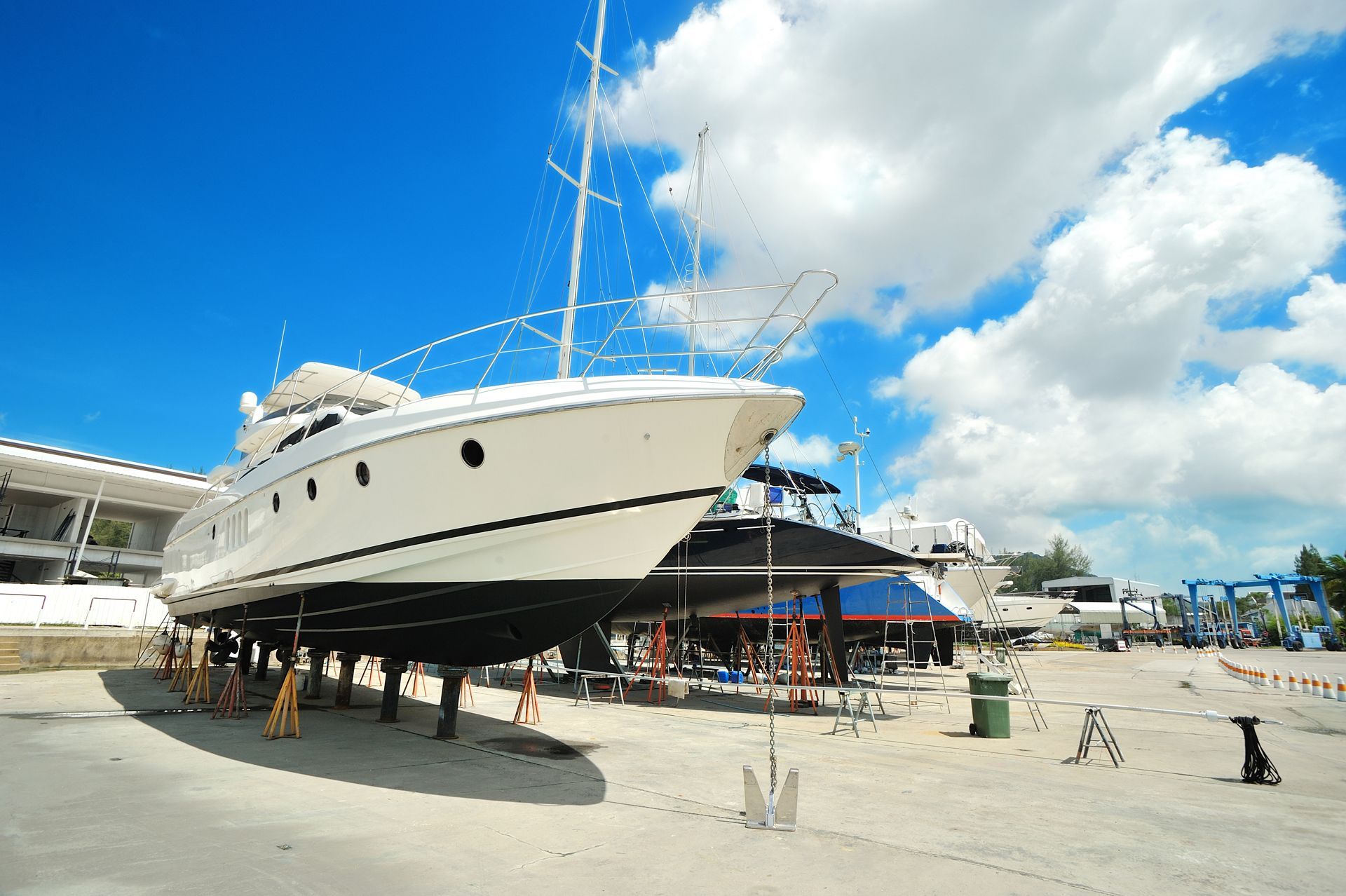 A Large White Boat is Sitting on the Ground in a Marina