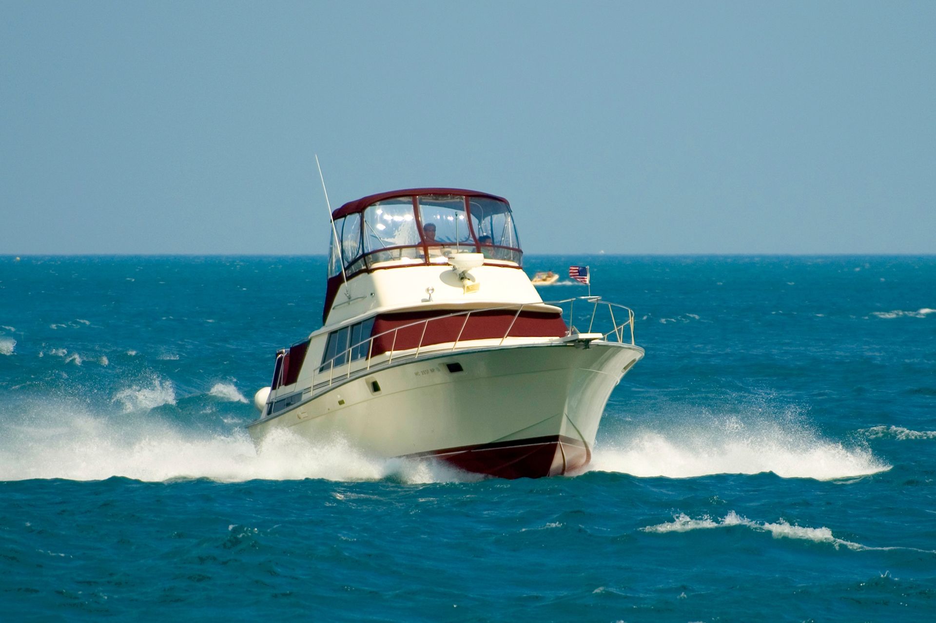 A Boat is Speeding Through the Ocean on a Sunny Day