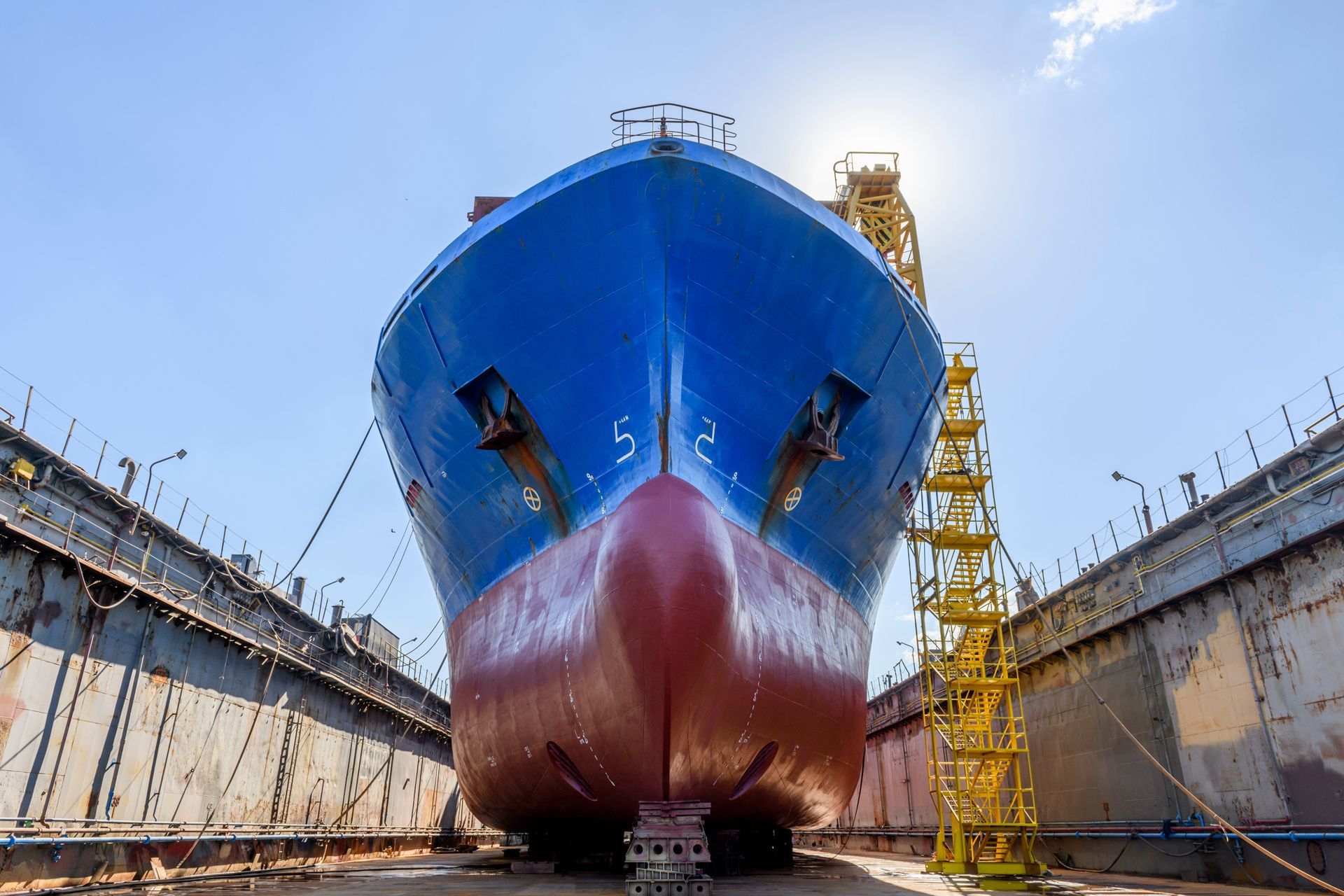 Blue and red cargo ship in dry dock