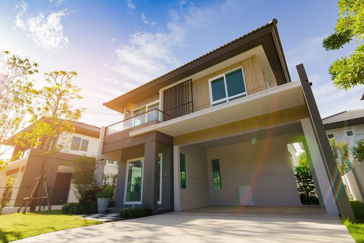 A large house with a lot of windows and a large garage