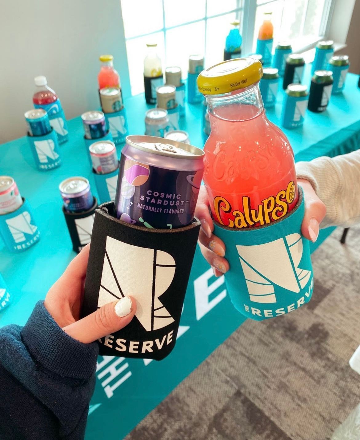 Two people holding drinks.