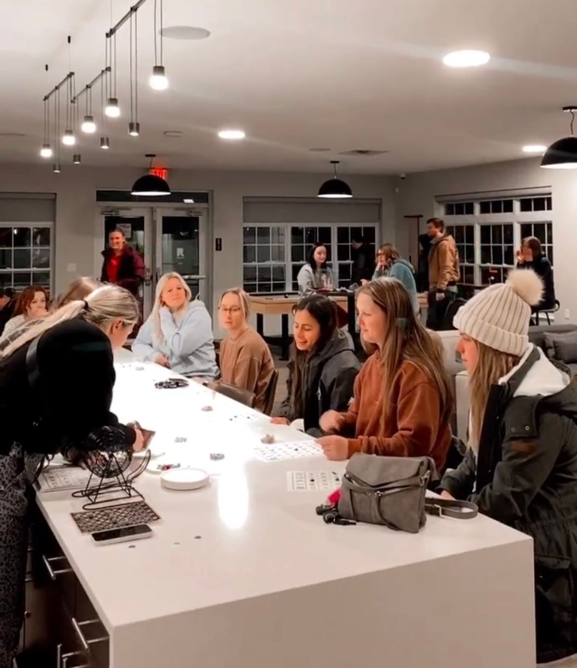 People gathered doing an activity at a counter.