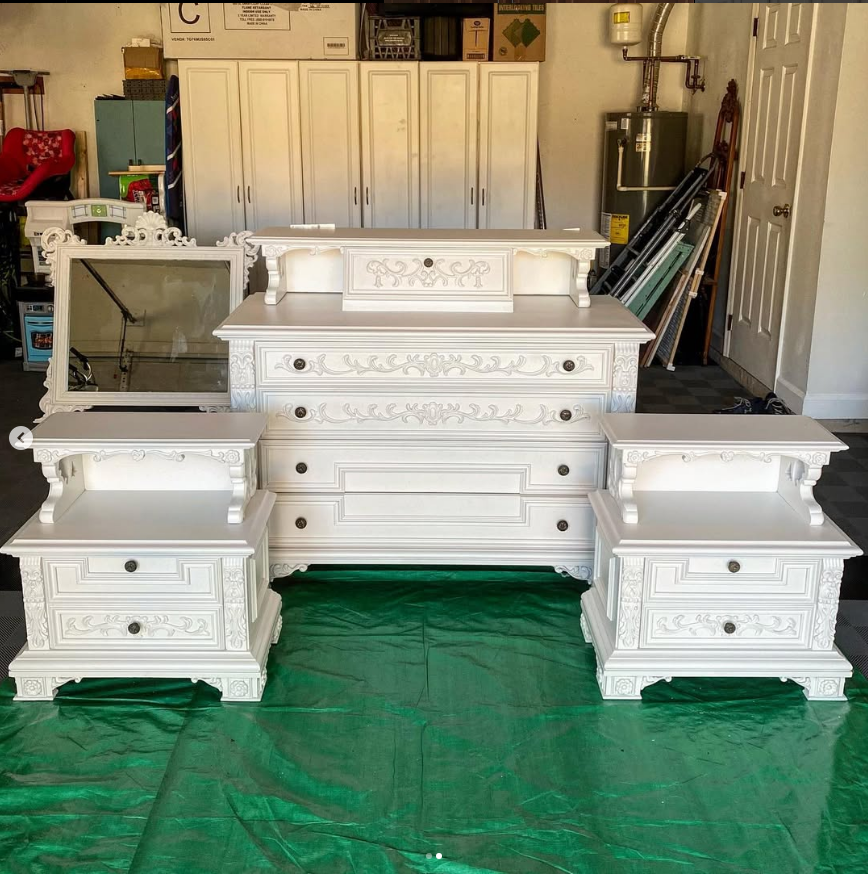 White bedroom furniture set, includes a dresser, two nightstands, and mirror.
