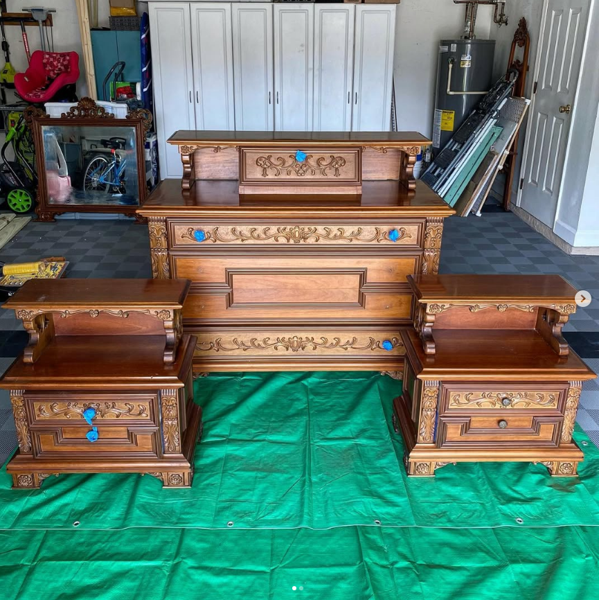 Ornate wooden bedroom set with headboard, nightstands, on green tarp.