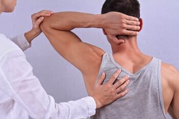 Doctor Stretching the Patient's Shoulder — Chiropractic Center in Cherry Hill, NJ