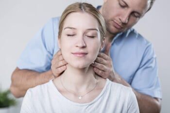 Woman Having Neck Massage — Chiropractic Center in Cherry Hill, NJ