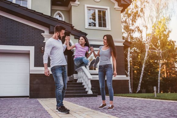 Family standing on paved driveway