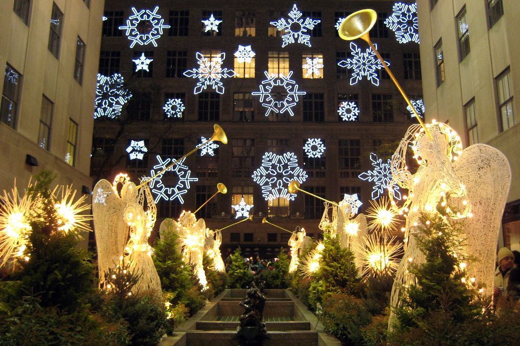Holiday scene at Rockefeller Center with angel sculptures and snowflake lights.Fifth Avenue