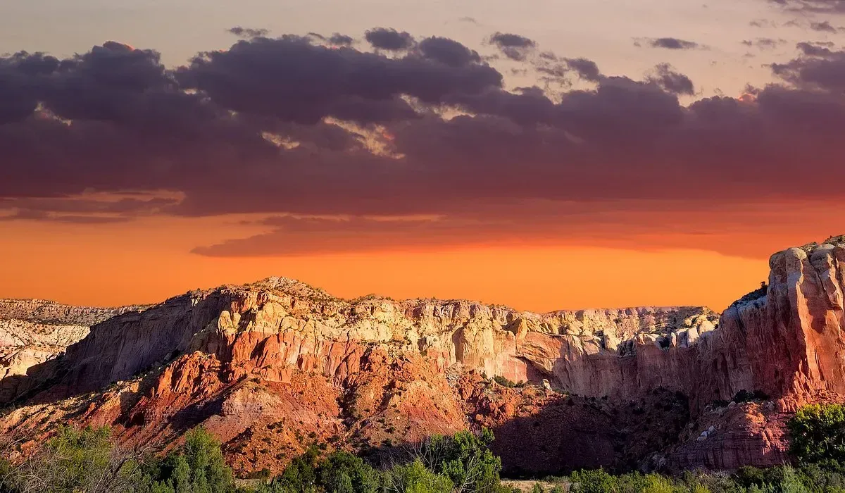 Red rock cliffs at sunset with orange and purple sky. Mexico