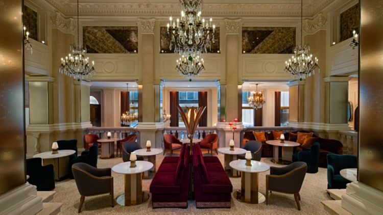 Elegant lounge with chandeliers, plush seating, and gold accents. St. Regis New York hotel dining