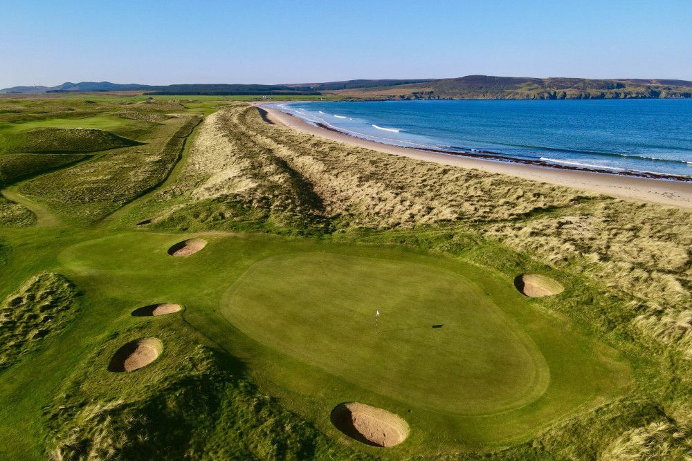 Golf course green with sand traps, near a beach and ocean. Royal Aberdeen