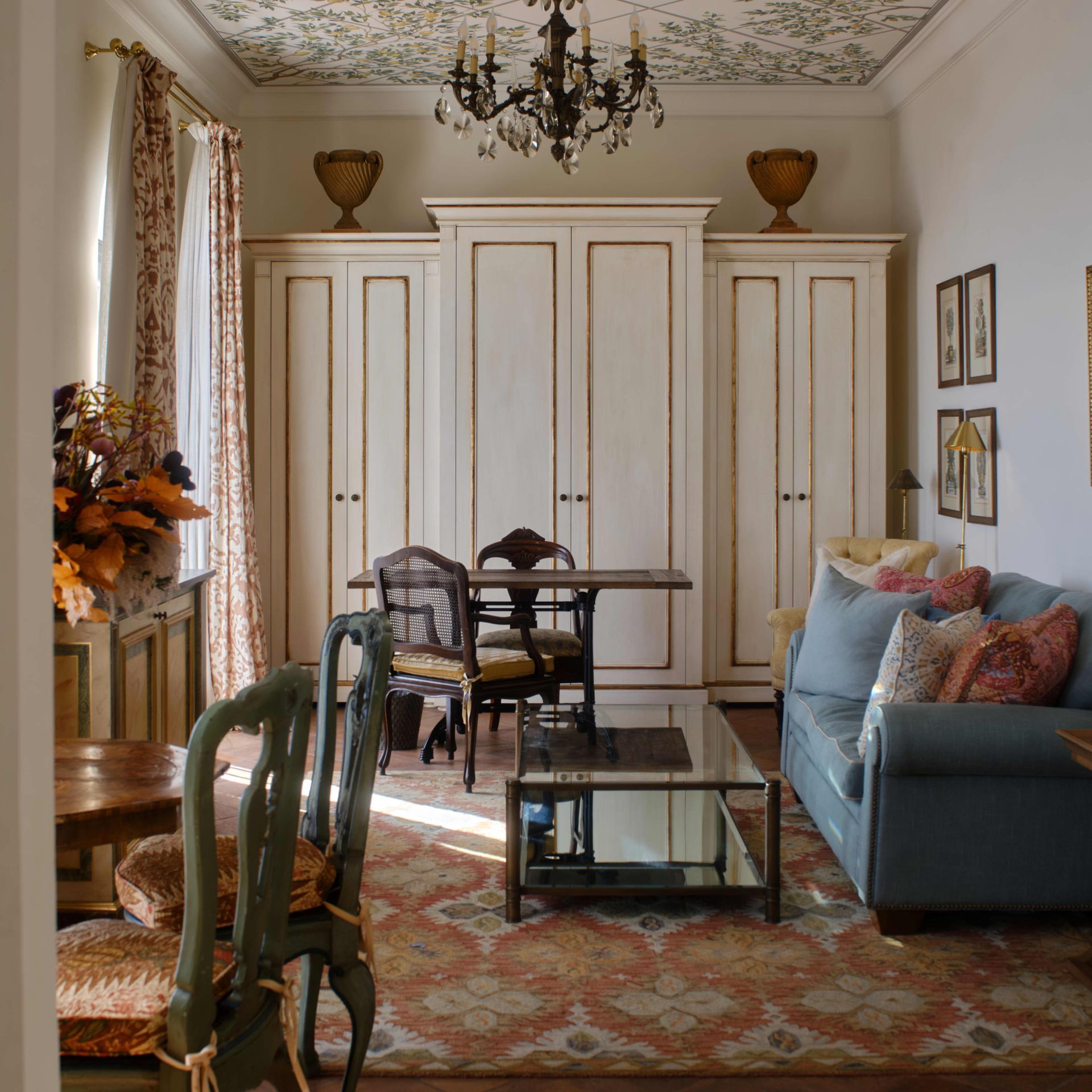 Stone walled garden with green grass, bushes, and two lounge chairs. The Belmond Hotel Caruso, Ravello