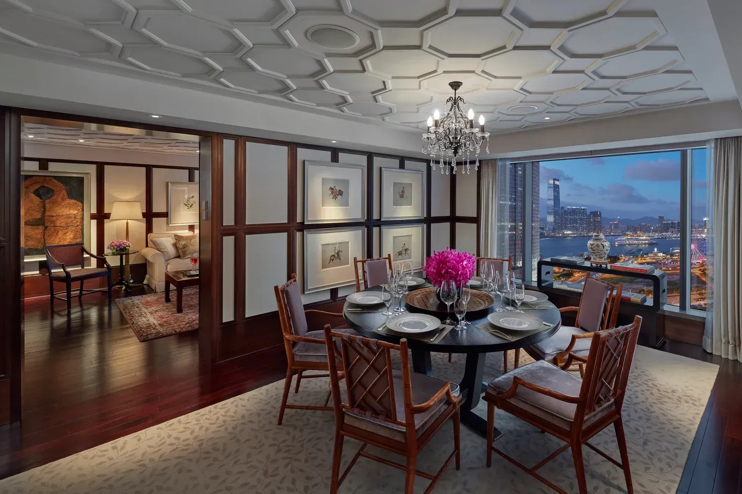 Elegant dining room with dark table, chandelier, and city view at dusk. The_Mandarin_Oriental_Hong Kong_