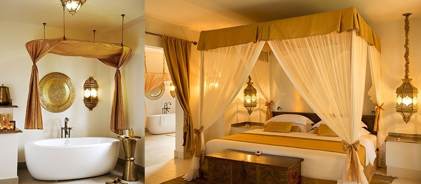 A split view of a hotel suite featuring a white bathtub and a four-poster bed with gold accents and hanging lanterns. Zanzibar White Sand Luxury Villas & Spa
